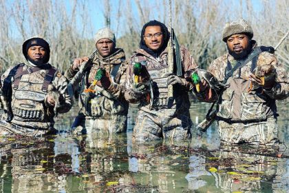 A group of men returning from hunting in winter with a full load.